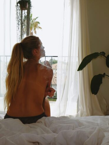 Woman sitting in soft morning light, reflecting and healing after ghosting.