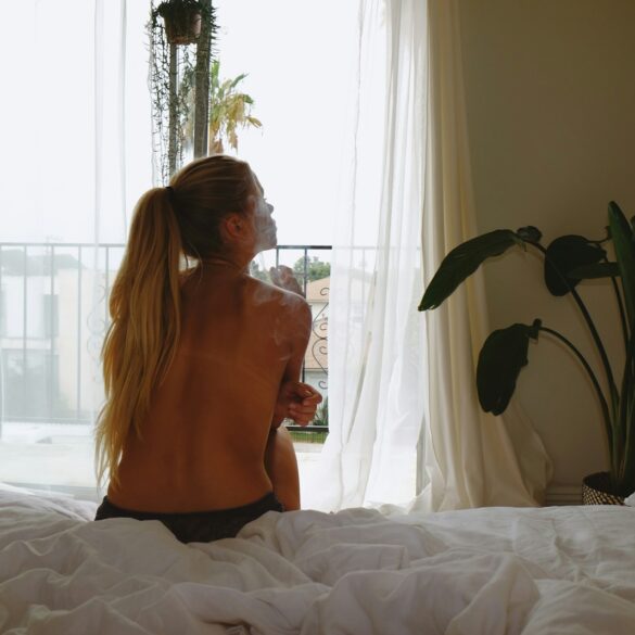 Woman sitting in soft morning light, reflecting and healing after ghosting.