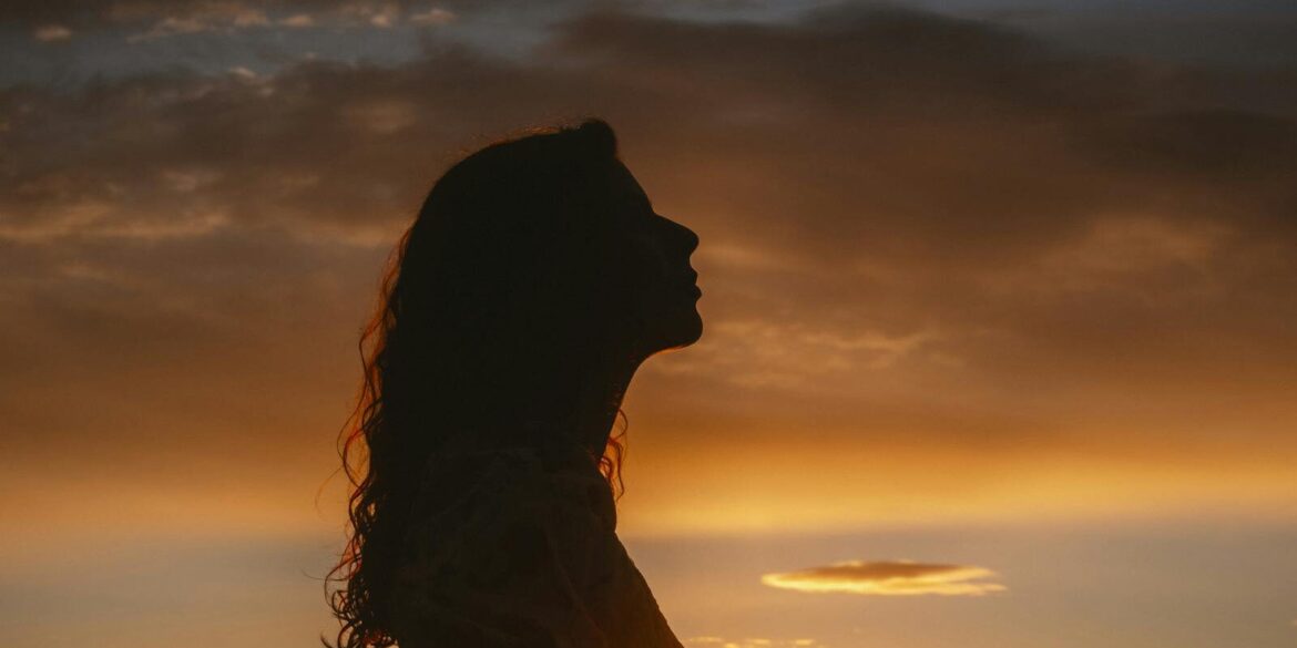 woman silhouette at sunset - horoscope
