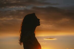 woman silhouette at sunset - horoscope
