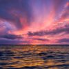 Stunning ocean view at sunset with colorful sky reflecting on the water.