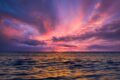 Stunning ocean view at sunset with colorful sky reflecting on the water.
